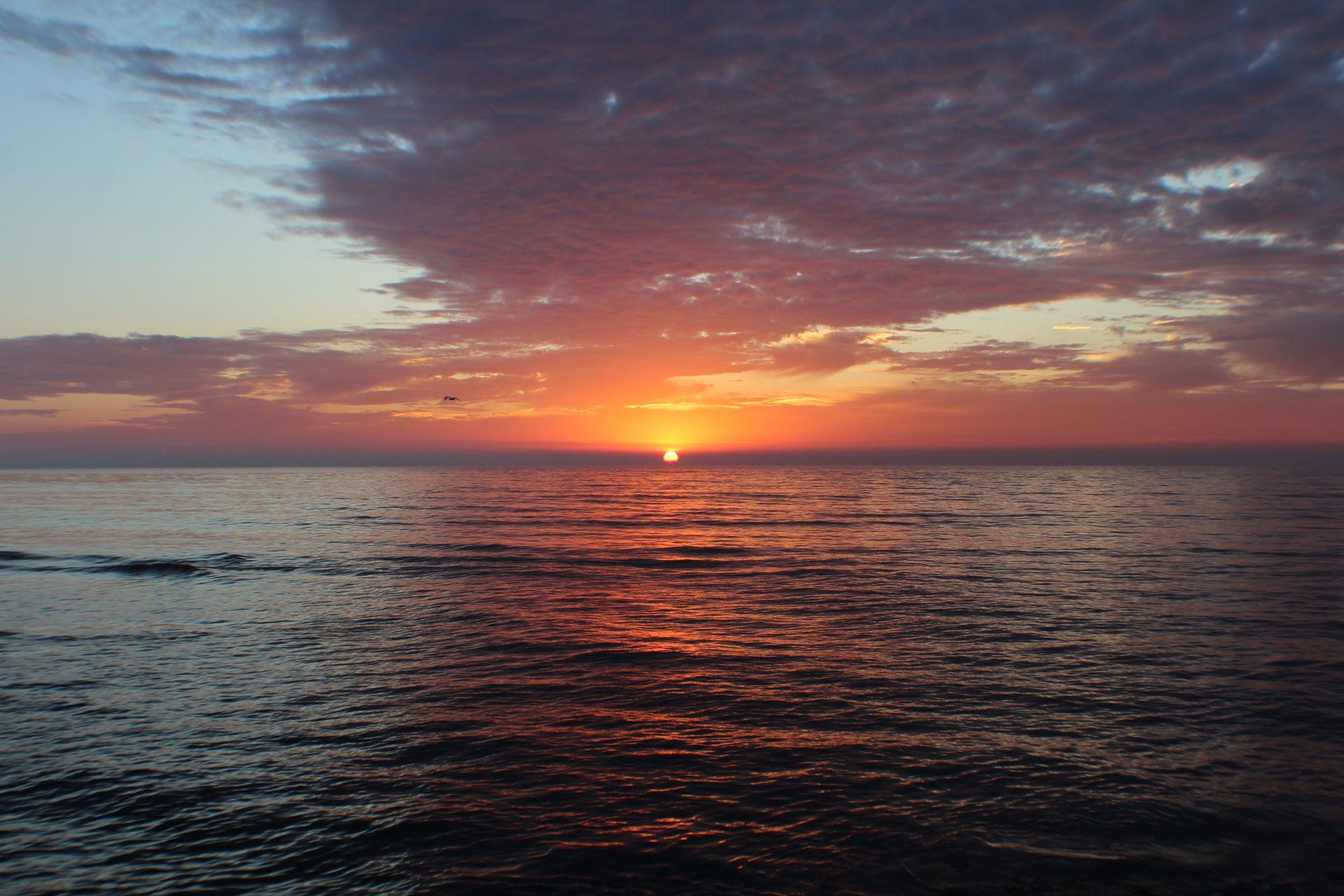 The sun setting over a calm sea at Rasdhoo